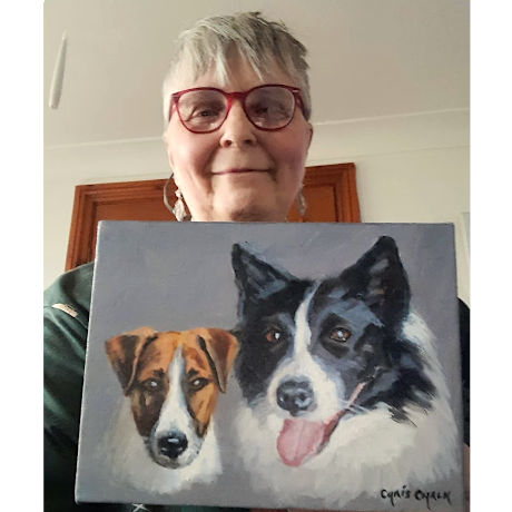 Client with their commissioned painting of two dogs a Collie and a Jack Russell